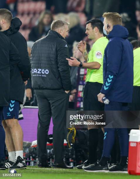 Head Coach Dean Smith of Aston Villa with referee Andy Madley after his sides 1-0 defeat during the Premier League match between Southampton and...