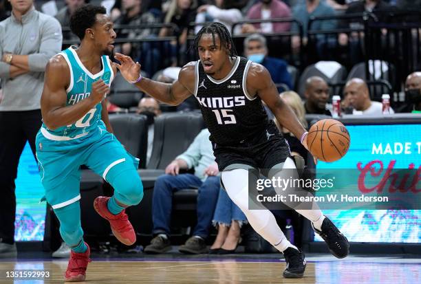 Davion Mitchell of the Sacramento Kings looks to drive to the basket on Ish Smith of the Charlotte Hornets during the first quarter at Golden 1...