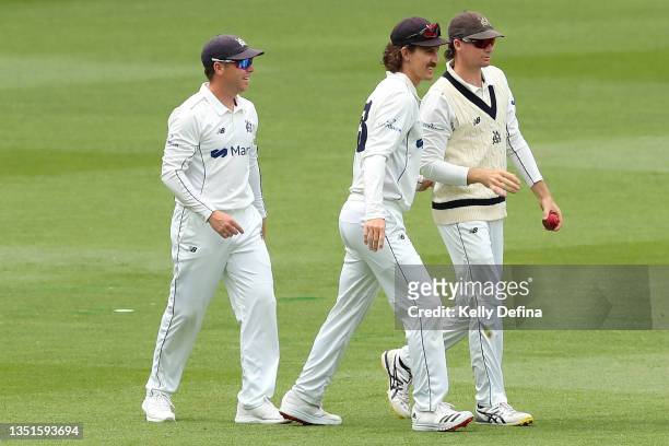 Peter Handscomb of Victoria, Nic Maddinson of Victoria and Marcus Harris of Victoria celebrate catching Jason Sangha of NSW during day two of the...