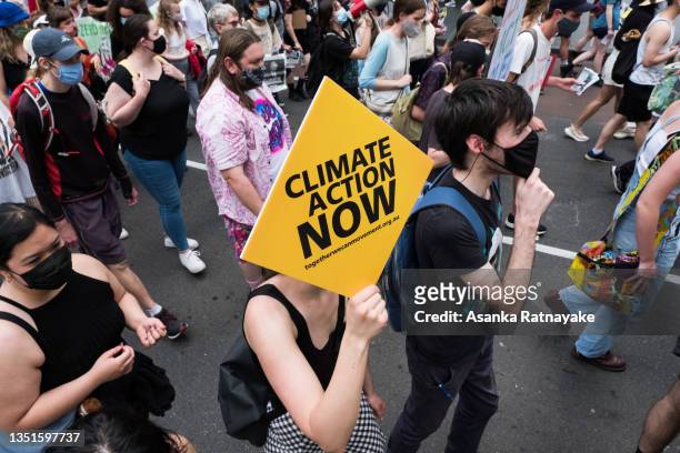 Climate change protestors are seen marching and changing as they carry placards on November 06, 2021 in Melbourne, Australia. Protests across...