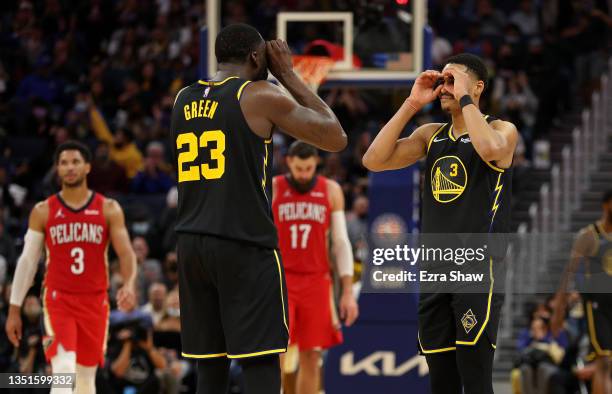 Jordan Poole and Draymond Green of the Golden State Warriors celebrate after the Warriors scored a basket against the New Orleans Pelicans at Chase...