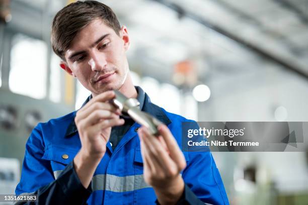 safety issues when using drilling machine tools. a machine operating cleaning and examining drill shank or drill sleeve, spindle hole before mounting before machining and drilling operation. - maschinenbau stock-fotos und bilder