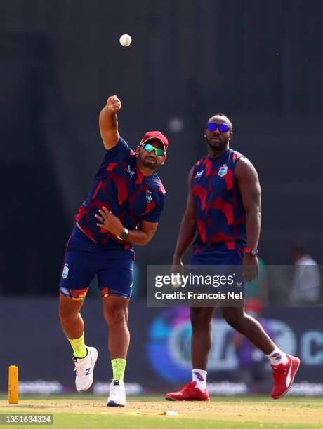 Andre Russel and Ravi Rampaul of West Indies warm up ahead of the ICC Men's T20 World Cup match between Australia and Windies at Sheikh Zayed stadium...