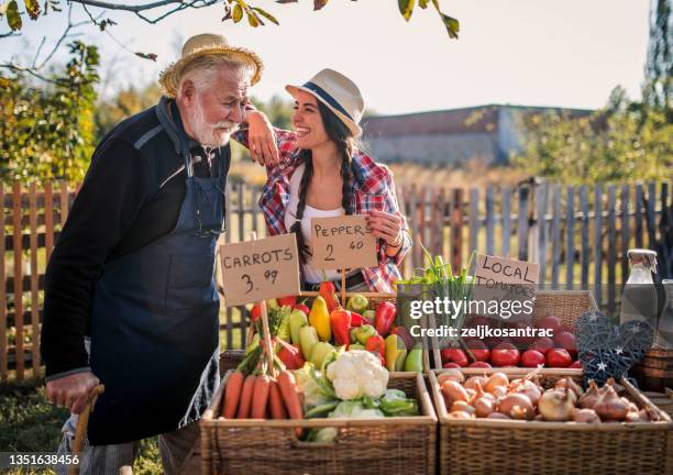farm workers  selling homegrown groceries on a market stand - homegrown produce stockfoto's en -beelden