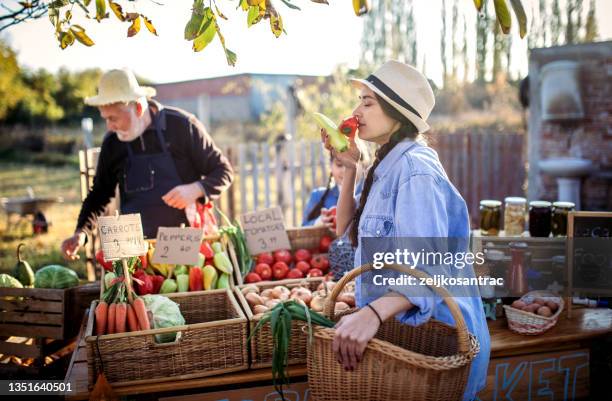farm workers  selling homegrown groceries on a market stand - ass six stock pictures, royalty-free photos & images