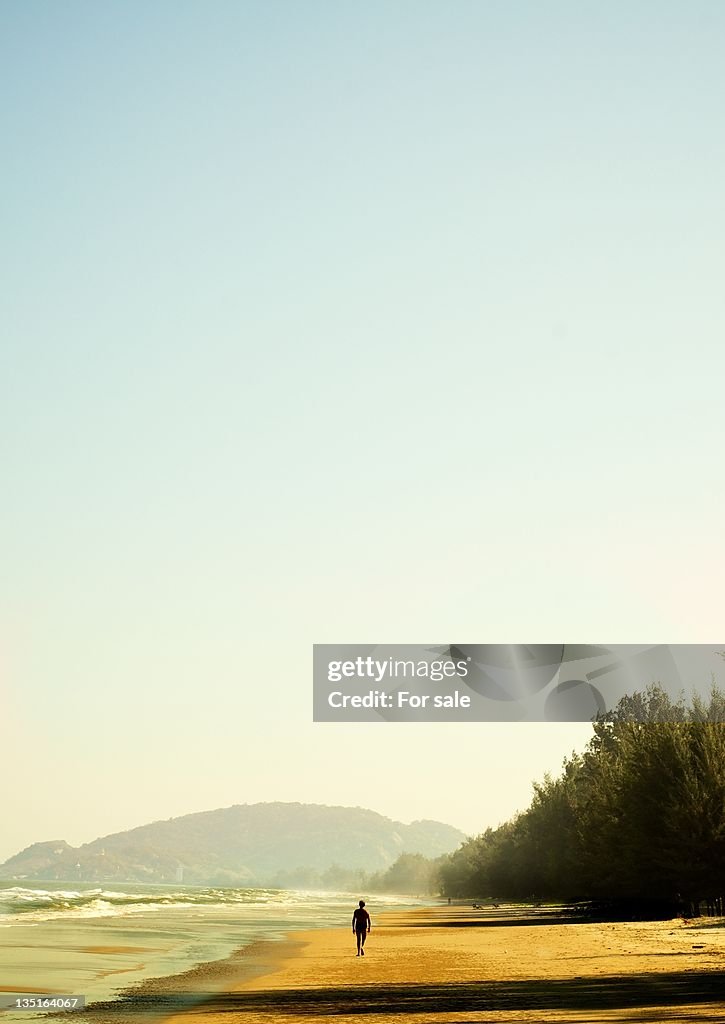 Person walking alone on beach