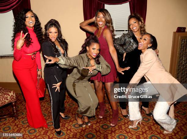 The Real Housewives of Atlanta" cast Marlo Hampton, Drew Sidora, Kandi Burruss, Kenya Moore, Sheree Whitfield and Sanya Richards-Ross pose backstage...