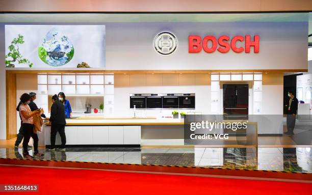 Visitors look at a kitchen at the Bosch booth during the 4th China International Import Expo at the National Exhibition and Convention Center on...