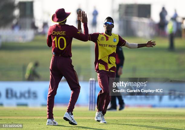 Akeal Hosein of West Indies celebrates the wicket of Aaron Finch of Australia with team mate Roston Chase during the ICC Men's T20 World Cup match...