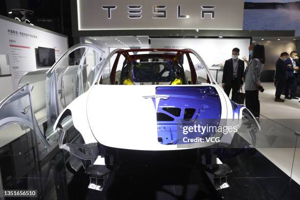People visit the Tesla booth during the 4th China International Import Expo at the National Exhibition and Convention Center on November 5, 2021 in...