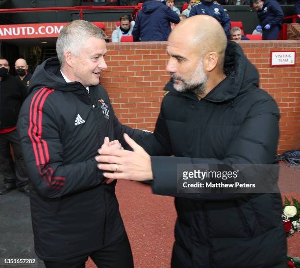 Manager Ole Gunnar Solskjaer of Manchester United greets Manager Pep Guardiola of Manchester City ahead of the Premier League match between...