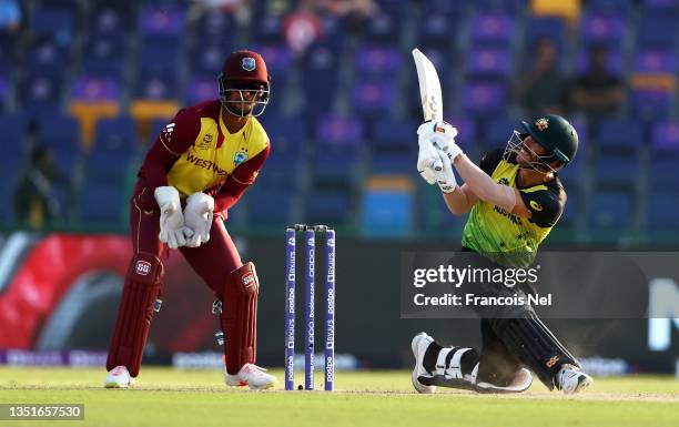 David Warner of Australia plays a shot as Nicholas Pooran of West Indies keeps during the ICC Men's T20 World Cup match between Australia and Windies...