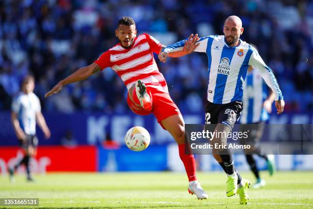 Luis Suarez of Granada CF is tackled by Aleix Vidal of RCD Espanyol during the La Liga Santander match between RCD Espanyol and Granada CF at RCDE...