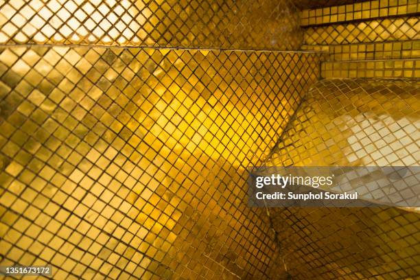 gold mosaic at the base of pagoda in wat phra kaew, bangkok thailand - royal background stock pictures, royalty-free photos & images