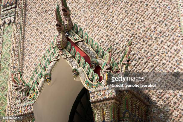 elaborate ceramic decoration at the base of the temple building in wat phra kaew or temple of the emerald buddha and grand palace in bangkok thailand - the emerald buddha temple in bangkok stock pictures, royalty-free photos & images