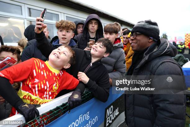 Former England footballer Ian Wright poses for photos with fans prior to the Emirates FA Cup First Round match between Banbury United and Barrow at...