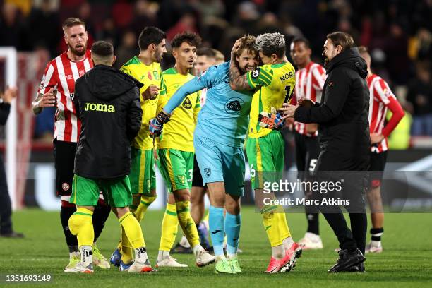 Tim Krul and Mathias Normann of Norwich City celebrate with Daniel Farke, Manager of Norwich City during the Premier League match between Brentford...