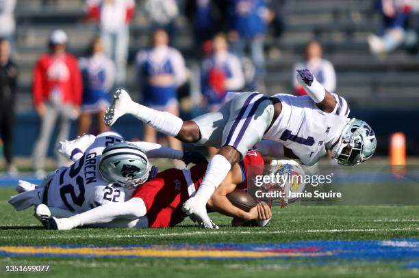 Quarterback Jason Bean of the Kansas Jayhawks is tackled by linebacker Daniel Green and defensive back Reggie Stubblefield of the Kansas State...