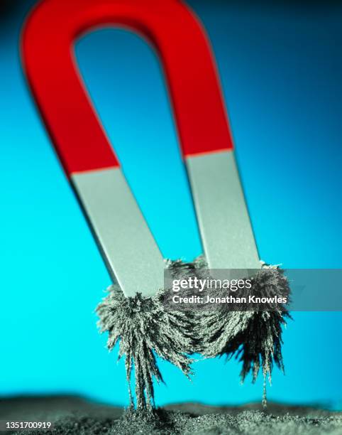 close up magnet and iron fillings - magnet iron filings stock pictures, royalty-free photos & images