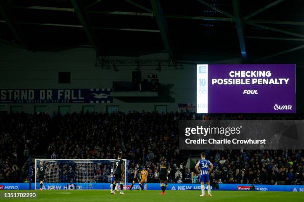 An LED screen shows a VAR check for a possible penalty for Brighton & Hove Albion, which is later given during the Premier League match between...