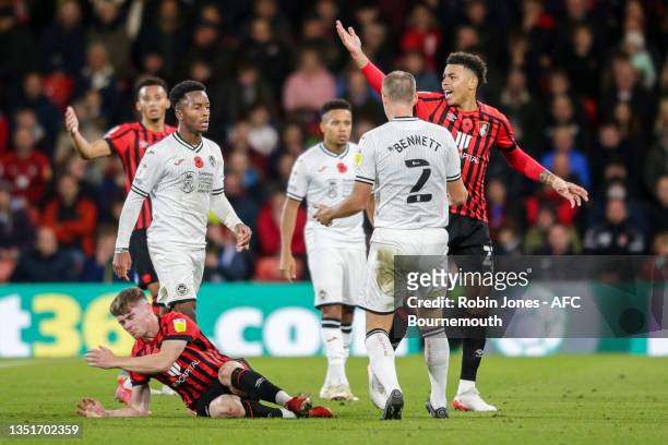 Ryan Bennett of Swansea City goes unpunished as he puts his shoulder into the face of Leif Davis of Bournemouth knocking him to the floor after Davis...