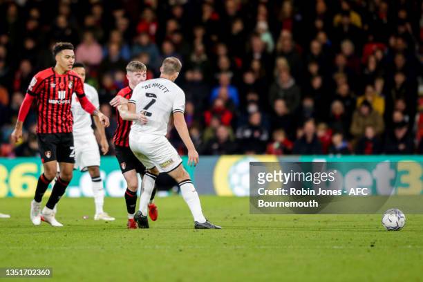 Ryan Bennett of Swansea City goes unpunished as he puts his shoulder into the face of Leif Davis of Bournemouth knocking him to the floor after Davis...