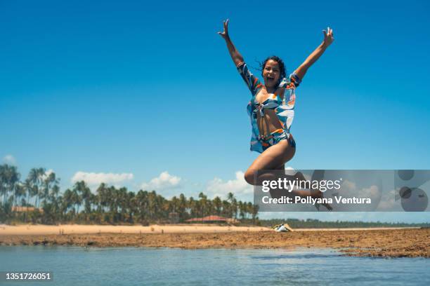 turista saltando en la piscina de coral en la playa - porto galinhas fotografías e imágenes de stock