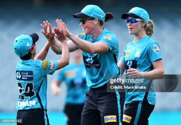 Grace Harris of the Brisbane Heat celebrates the wicket of Tahlia Wilson of the Sydney Thunder with Poonam Yadav of the Brisbane Heat during the...