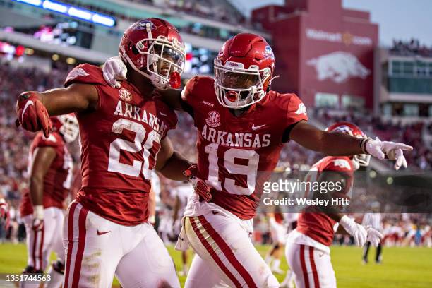 Dominique Johnson celebrates with Tyson Morris of the Arkansas Razorbacks after scoring the game winning touchdonw in the second half of a game...