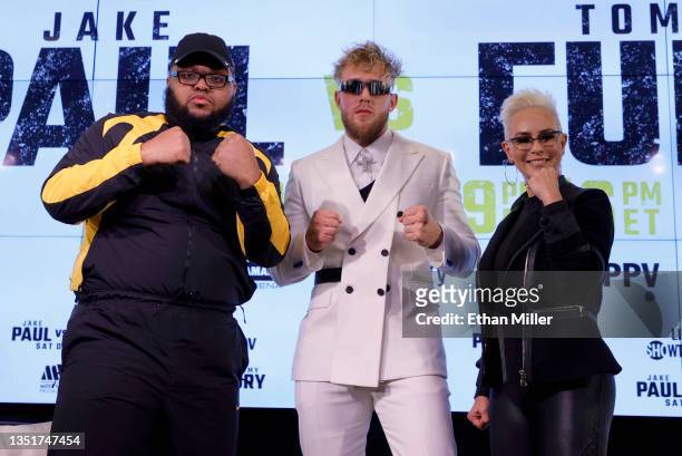 Comedian Drew "Druski" Desbordes as "Coach D," Jake Paul and Showtime boxing host Claudia Trejos pose during a news conference to promote Paul's...