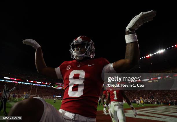 John Metchie III of the Alabama Crimson Tide reacts after pulling in a touchdown reception against the LSU Tigers during the first half at...