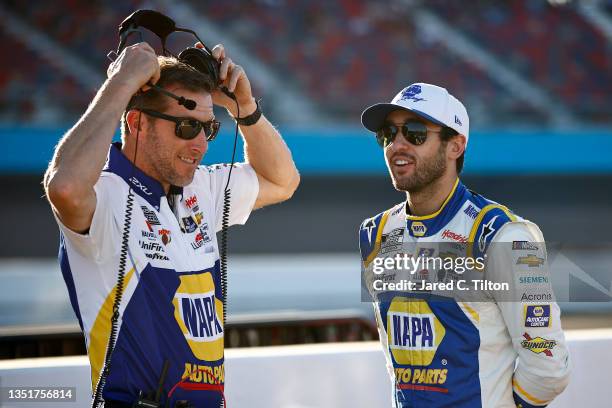 Chase Elliott, driver of the NAPA Auto Parts Chevrolet, and crew chief Alan Gustafson talk on the grid during qualifying for the NASCAR Cup Series...