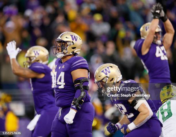 Sam Taimani of the Washington Huskies and the defense celebrate after a safety against the Oregon Ducks during the first quarter at Husky Stadium on...