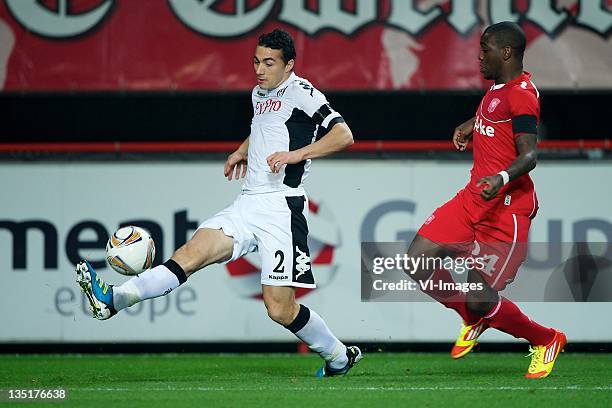 Stephen Kelly of Fulham,Ola John of FC Twente during the Europa League match between FC Twente and Fulham FC at the Grolsch Veste Stadium on December...