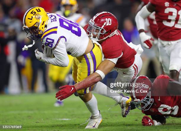Jack Bech of the LSU Tigers takes this reception in for a touchdown against Henry To'oTo'o and Christian Harris of the Alabama Crimson Tide during...