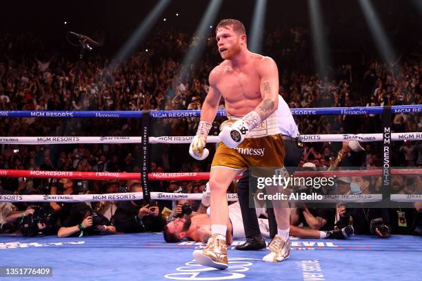 Canelo Alvarez walks away after knocking out Caleb Plant in the 11th round during their championship bout for Alvarez's WBC, WBO and WBA super...