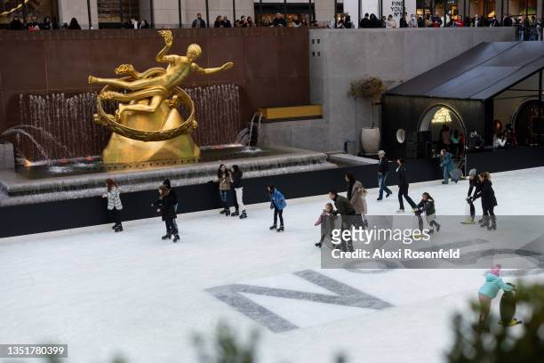 People ice skate near a Chanel No. 5 logo at The Rink in Rockefeller Center on November 06, 2021 in New York City. In honor of Chanel No. 5 turning...