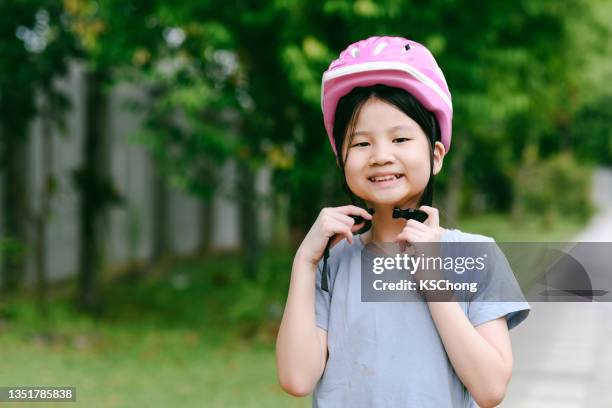 happy cute asian girl putting cycle helmet on - daily sport girls bildbanksfoton och bilder