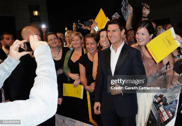 Actor Tom Cruise poses with fans as he attends the "Mission: Impossible - Ghost Protocol" Premiere during day one of the 8th Annual Dubai...