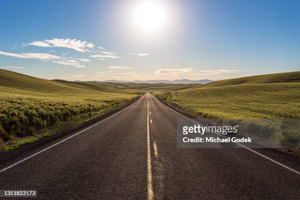 stunning morning view of road through the palouse hills - springtime road stock pictures, royalty-free photos & images
