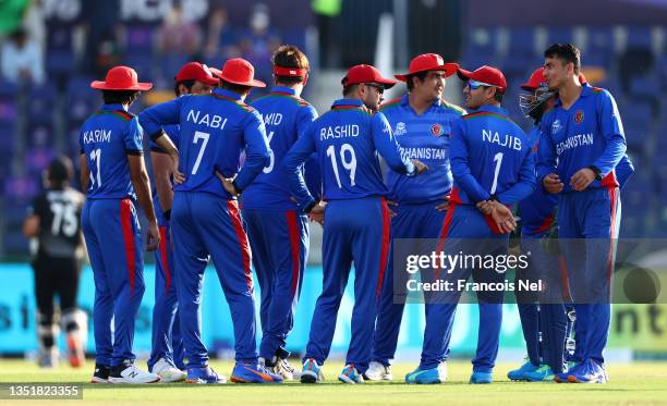 Mujeeb Ur Rahman of Afghanistan celebrates the wicket of Daryl Mitchell of New Zealand during the ICC Men's T20 World Cup match between New Zealand...