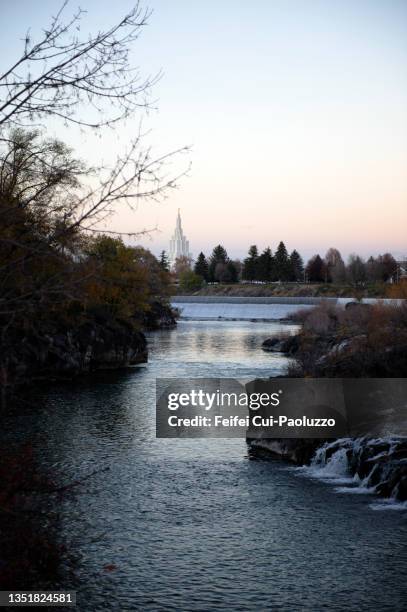 Falls On The Snake River And Tower Of Idaho Falls Idaho Temple At Autumn High-Res Stock Photo