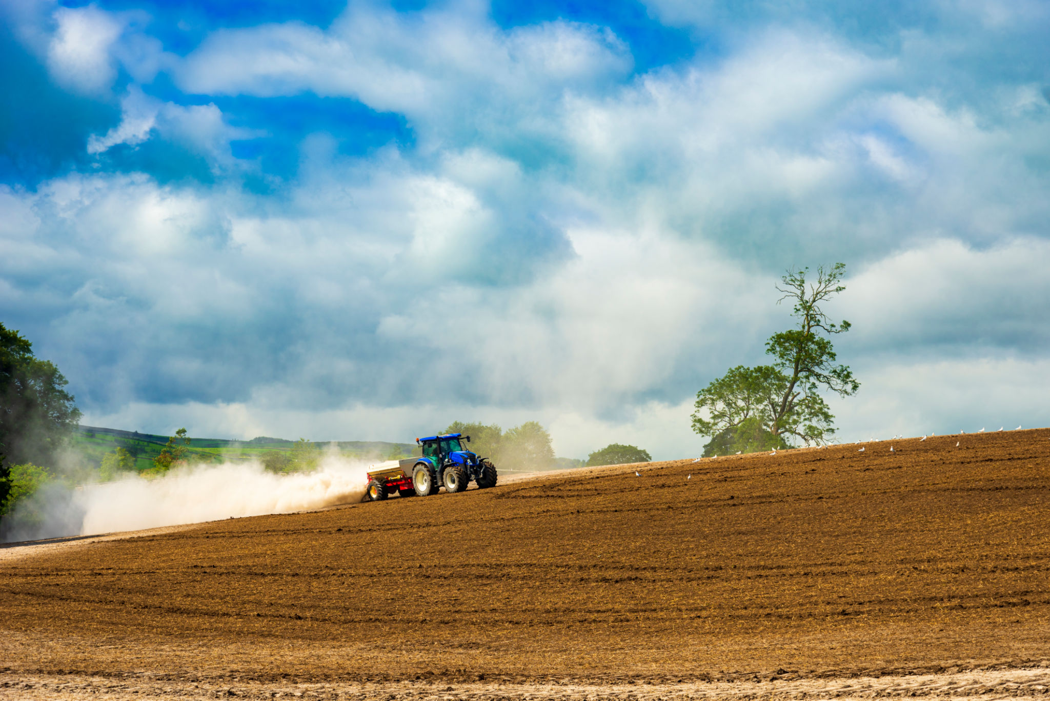Tractor ploughs a field on a Yorkshire farm Tractor ploughs a field on a Yorkshire farm