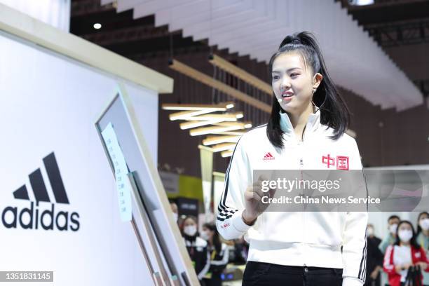 Volleyball player Zhang Changning is seen at Adidas booth during the 4th China International Import Expo at the National Exhibition and Convention...