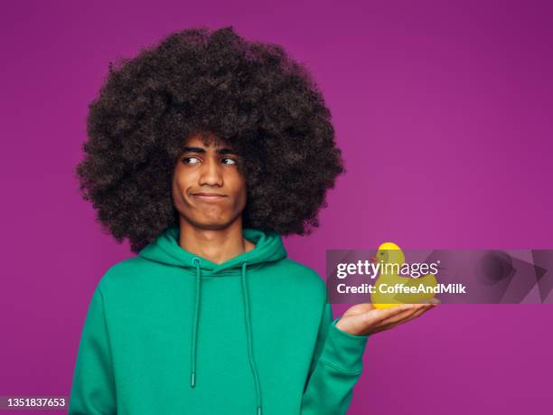 portrait of afro guy with rubber duck - sad rubber duck stock pictures, royalty-free photos & images