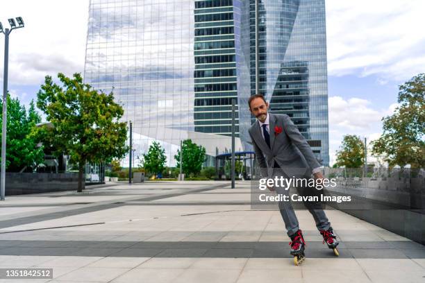 executive skating with his inline skates - inline skate stock pictures, royalty-free photos & images