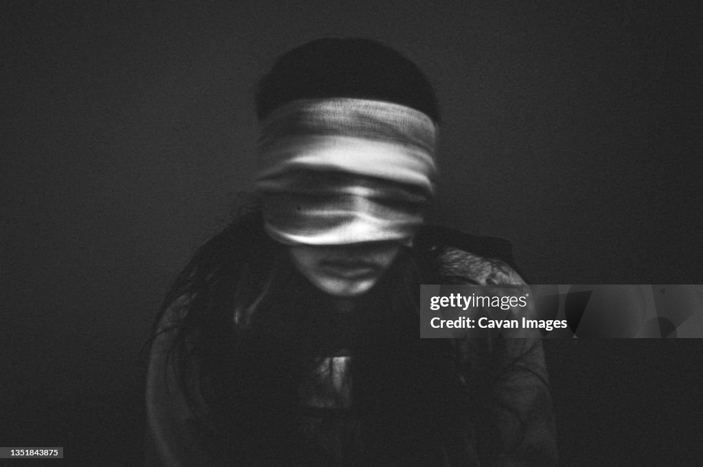 Portrait of creepy girl with bandages over her eyes