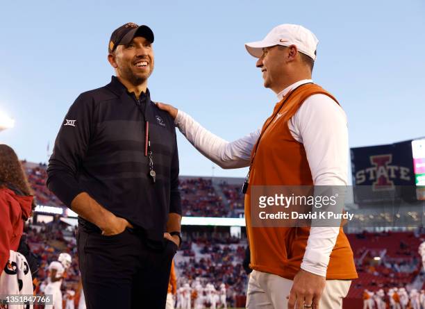 Head coach Matt Campbell of the Iowa State Cyclones meets with head coach Steve Sarkisian of the Texas Longhorns at midfield during pregame warmups...