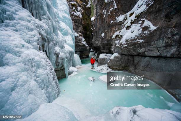hiking through frozen maligne canyon - jasper canada stock pictures, royalty-free photos & images