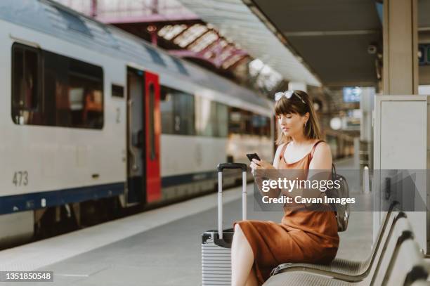 tourist woman sitting in antwerp train station - antwerp city belgium stock pictures, royalty-free photos & images